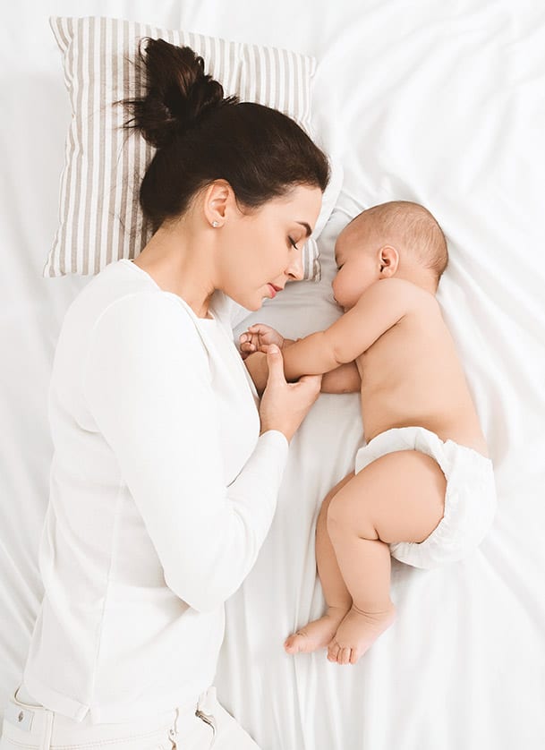 Mother sleeping with baby